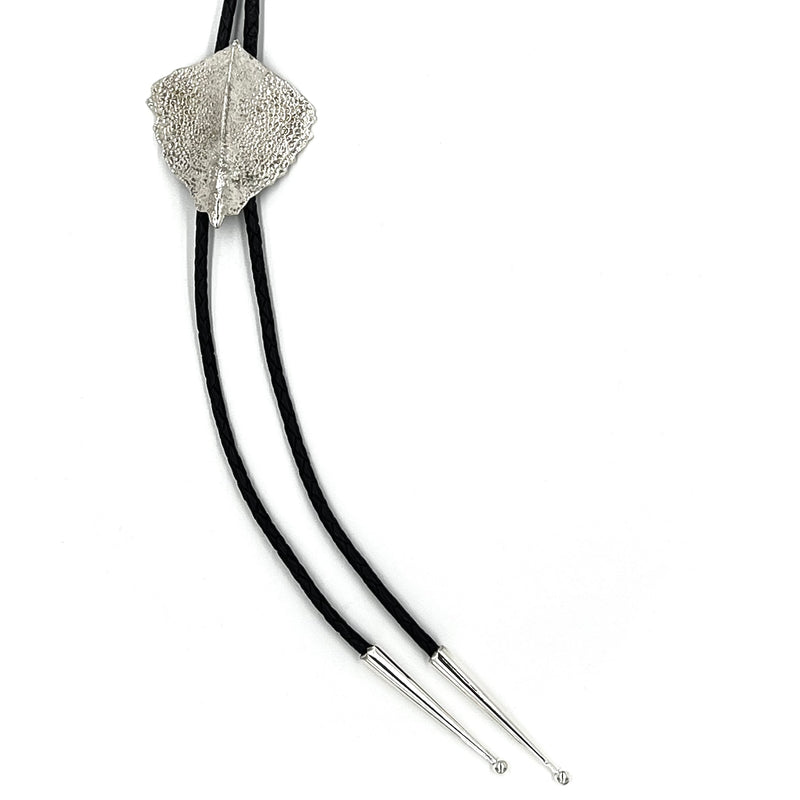 A sturgeon plate bolo on thin black leather with sterling silver tips